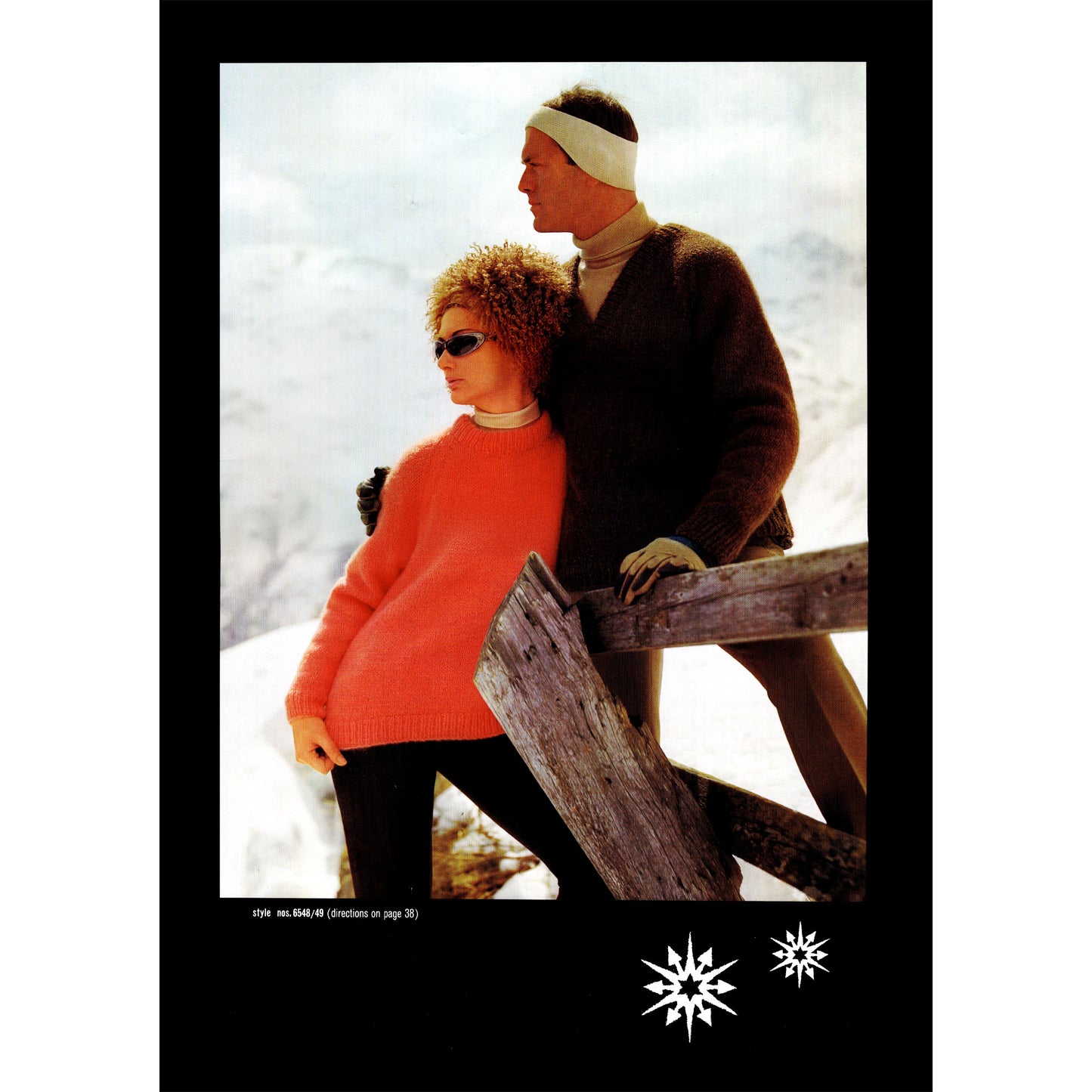 Two people standing close together in a snowy landscape, wearing hand knit sweaters