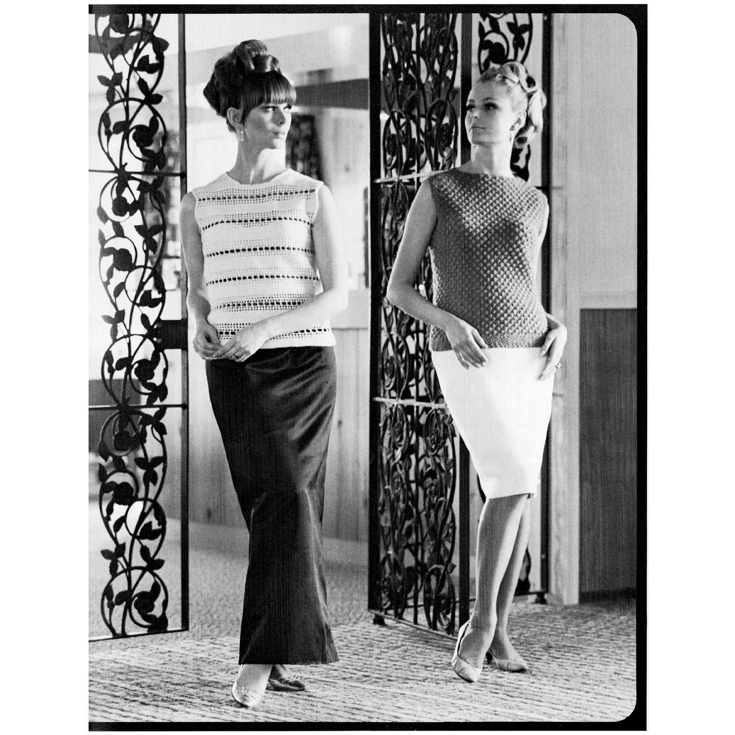 Two women modeling crocheted  outfits in a black and white photo, standing in front of decorative screens.