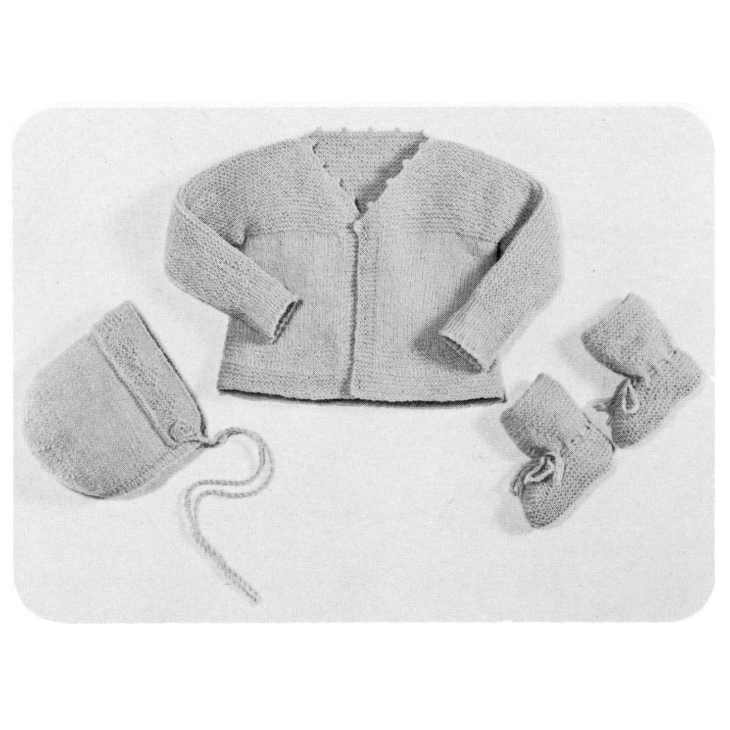 Black and white photo of a baby cardigan, hat, and mittens set on a white background