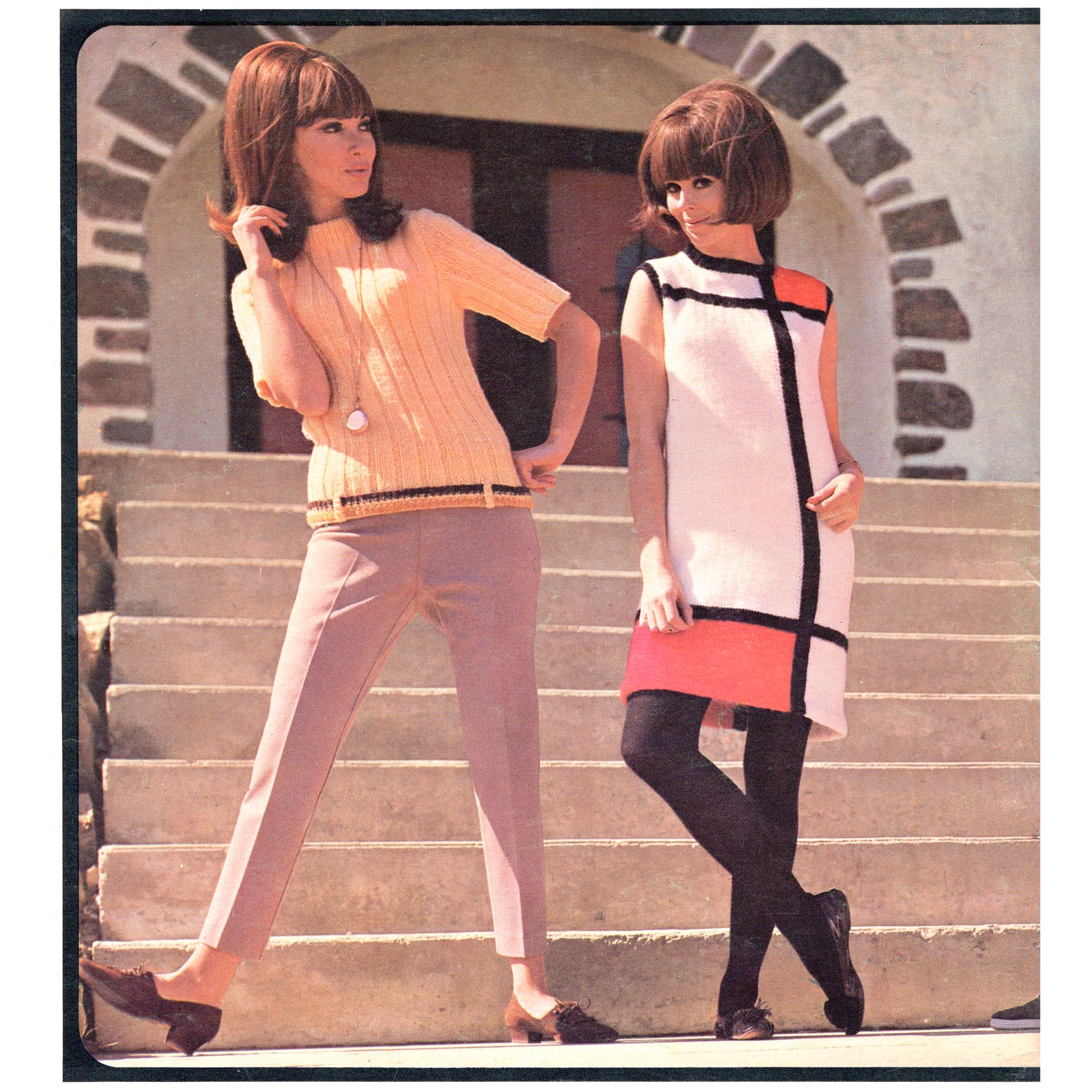 Two women in vintage clothing standing on stone steps. One is wearing a Mondrian-inspired sheath dress, the other a short-sleeved sweater