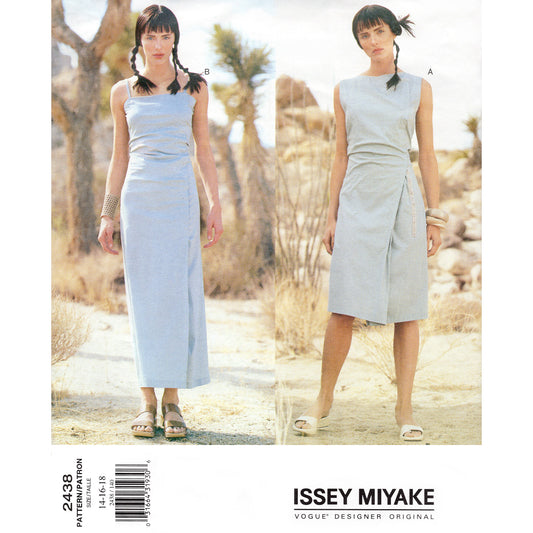 Vogue pattern 2438 envelope cover showing two models wearing light blue dresses by Issey Miyake in a desert setting.