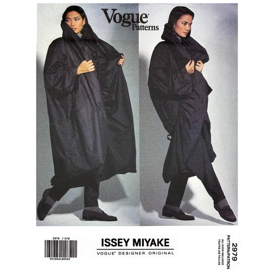 Vogue pattern 2979 envelope cover showing two views of a model wearing a reversible coat by Issey Miyake against a gray background.